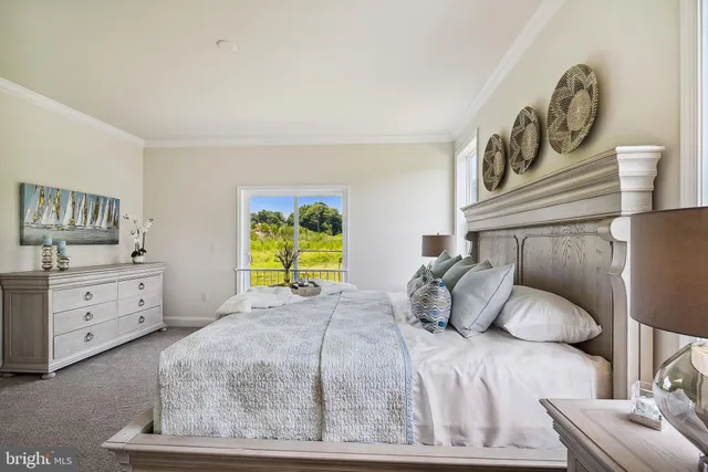 a bedroom with a bed and painting on the wall