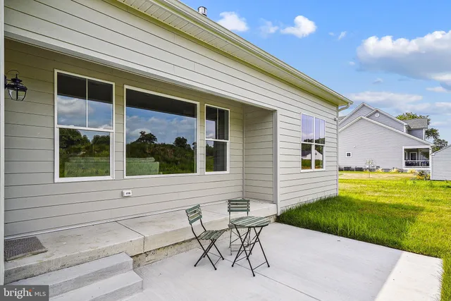 a view of a house with a yard and sitting area