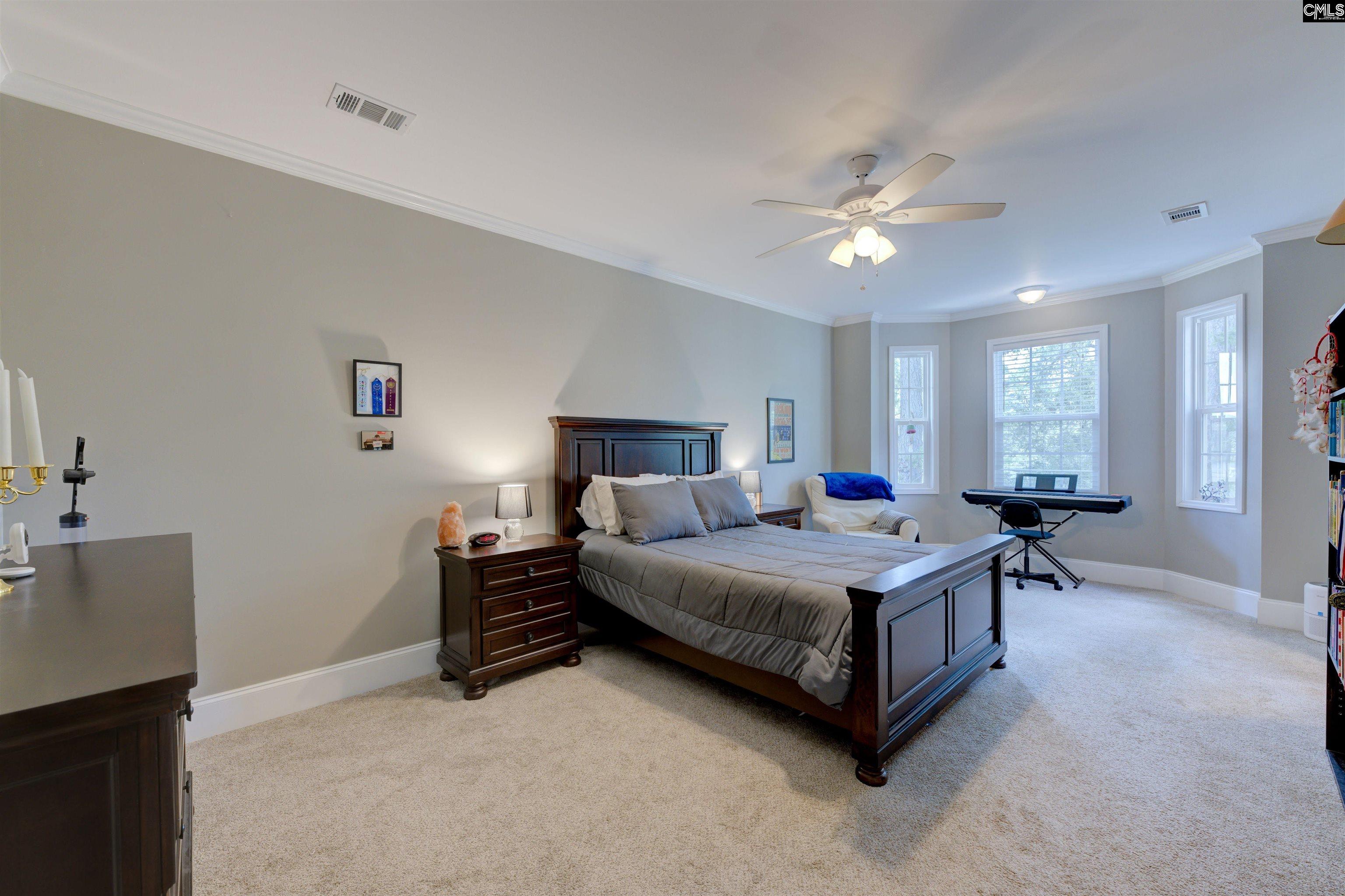 305 Northlake Road Columbia, SC 29223 - Photo 36 of 46 a living room with a bed furniture a chandelier and closet