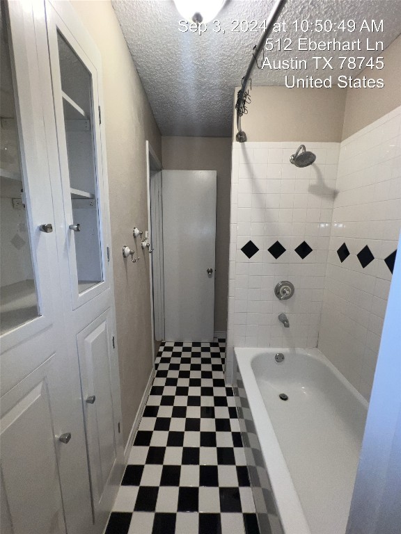 512 Eberhart Lane, Unit 103 Austin, TX 78745 - Photo 13 of 18 a bathroom with a bathtub and a shower