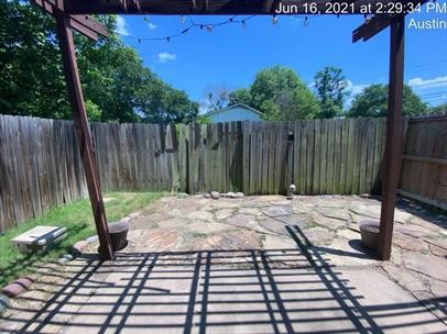 512 Eberhart Lane, Unit 103 Austin, TX 78745 - Photo 17 of 18 a lawn chairs sitting in a backyard with wooden fence