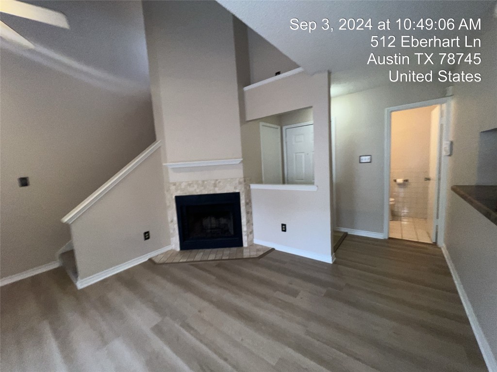 512 Eberhart Lane, Unit 103 Austin, TX 78745 - Photo 2 of 18 a view of a livingroom with wooden floor and staircase