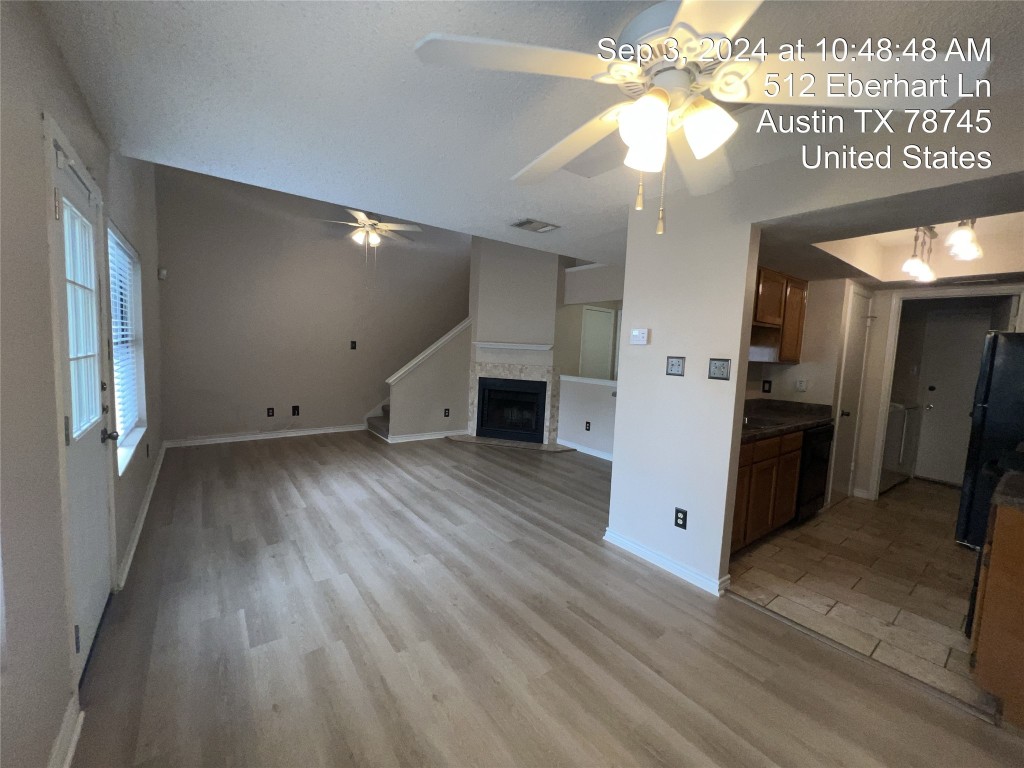 512 Eberhart Lane, Unit 103 Austin, TX 78745 - Photo 3 of 18 an empty room with wooden floor chandelier and entryway