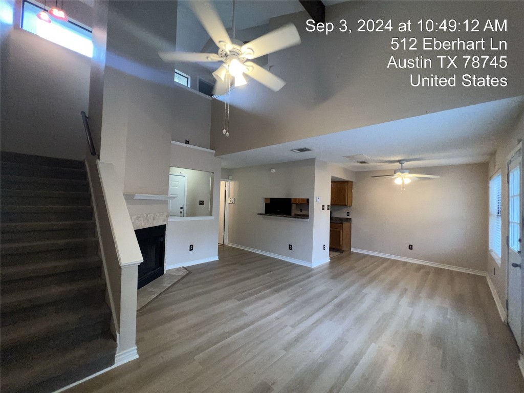 512 Eberhart Lane, Unit 103 Austin, TX 78745 - Photo 8 of 18 wooden floor in an empty room with a fireplace