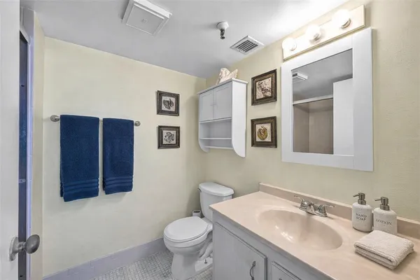 a bathroom with a sink vanity and toilet