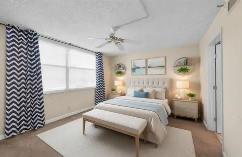 a bedroom with a bed and a window