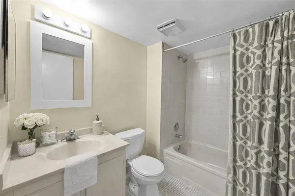 a bathroom with a sink toilet tub and shower
