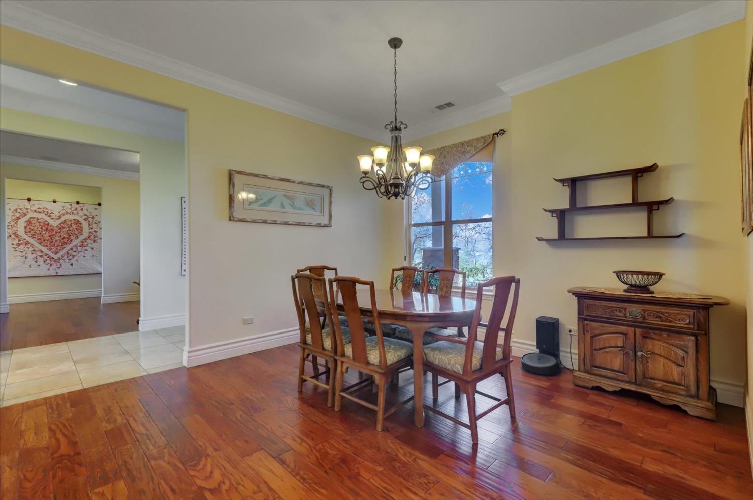 13197 American Ranch Court Grass Valley, CA 95949 - Photo 18 of 77 a view of a dining room with furniture wooden floor and chandelier
