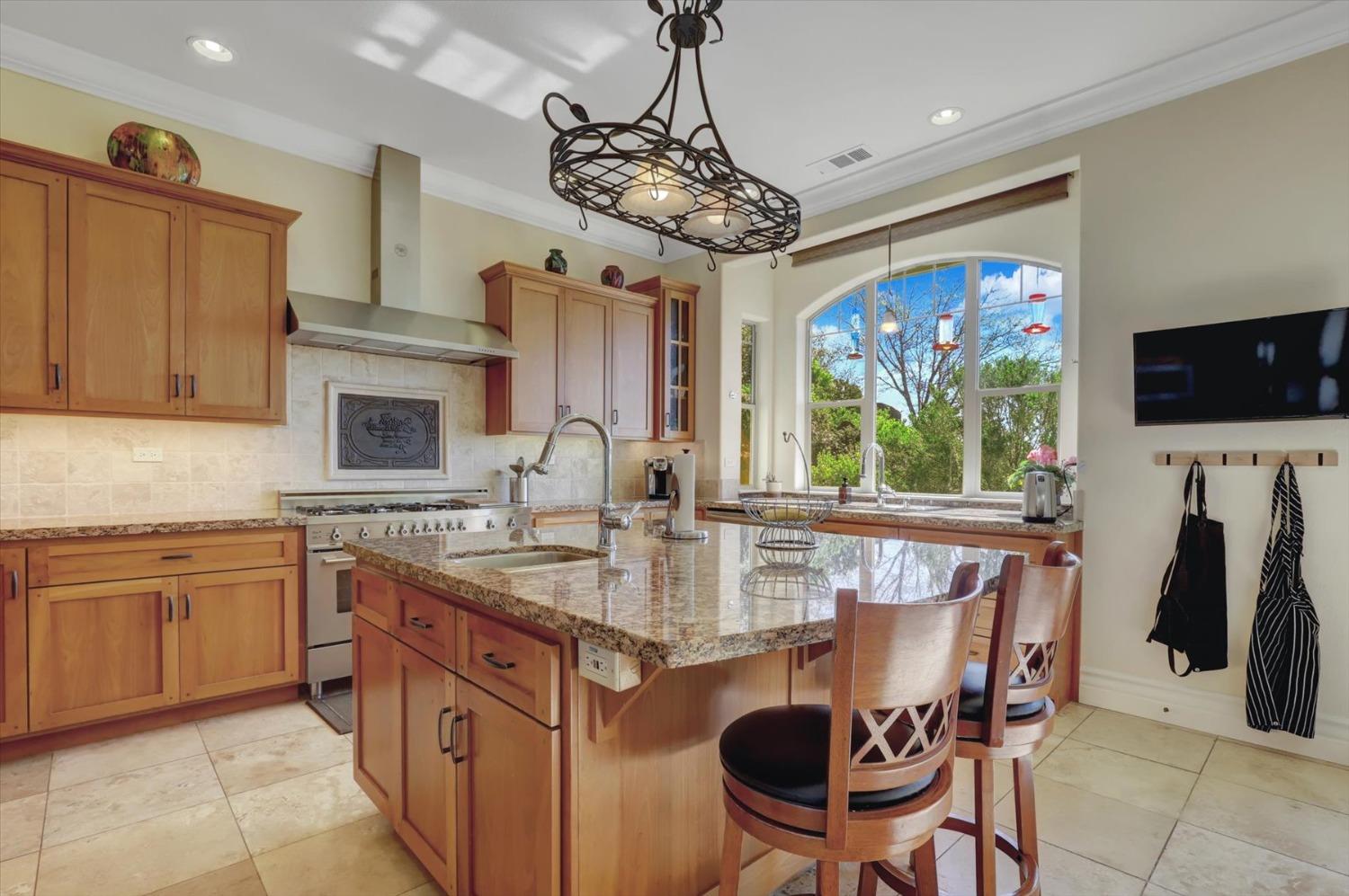 13197 American Ranch Court Grass Valley, CA 95949 - Photo 24 of 77 a kitchen with stainless steel appliances granite countertop a sink and a refrigerator
