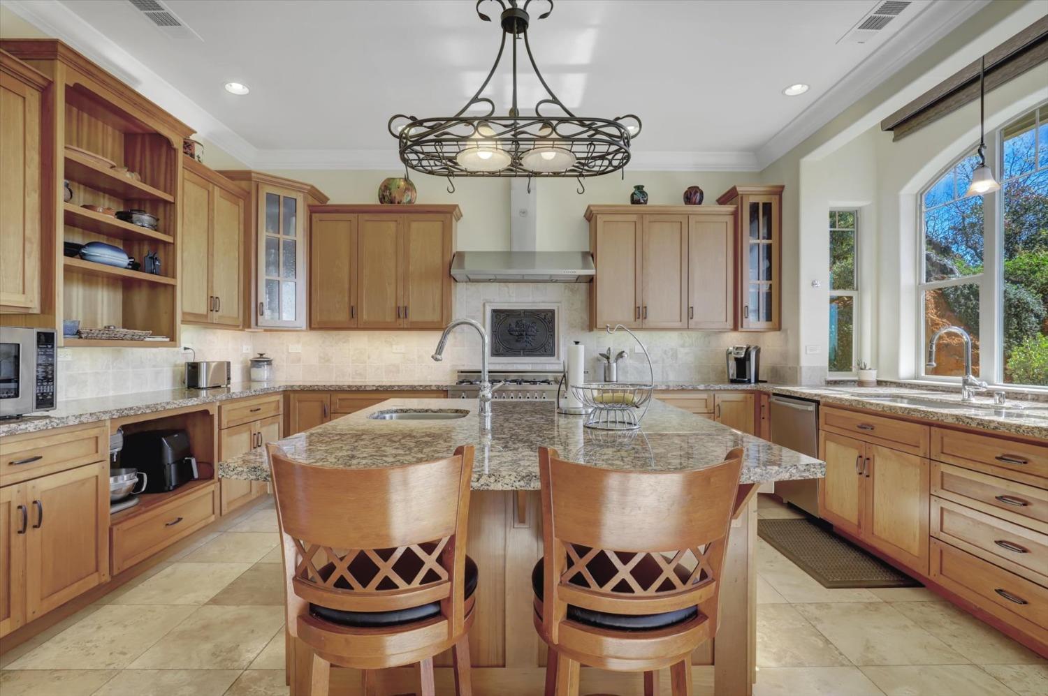 13197 American Ranch Court Grass Valley, CA 95949 - Photo 30 of 77 a large kitchen with stainless steel appliances granite countertop a stove and a sink