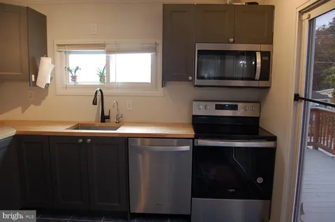 a kitchen with a sink and a microwave
