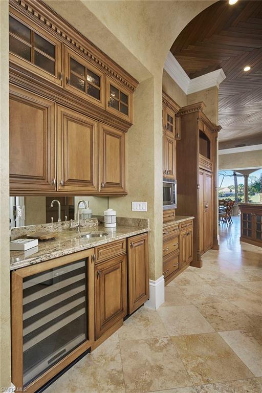 2944 Bellflower Lane Naples, FL 34105 - Photo 12 of 48 a kitchen with stainless steel appliances granite countertop a sink and cabinets