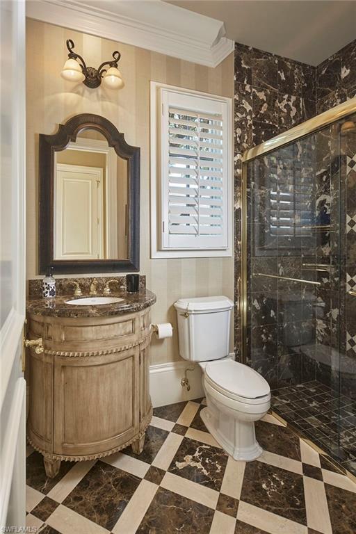 2944 Bellflower Lane Naples, FL 34105 - Photo 25 of 48 a bathroom with a toilet a sink and a shower