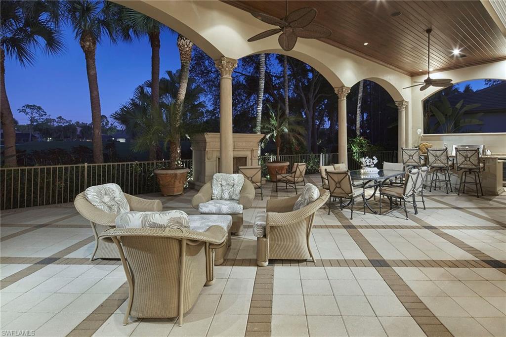 2944 Bellflower Lane Naples, FL 34105 - Photo 45 of 48 a view of a patio with dining table and chairs
