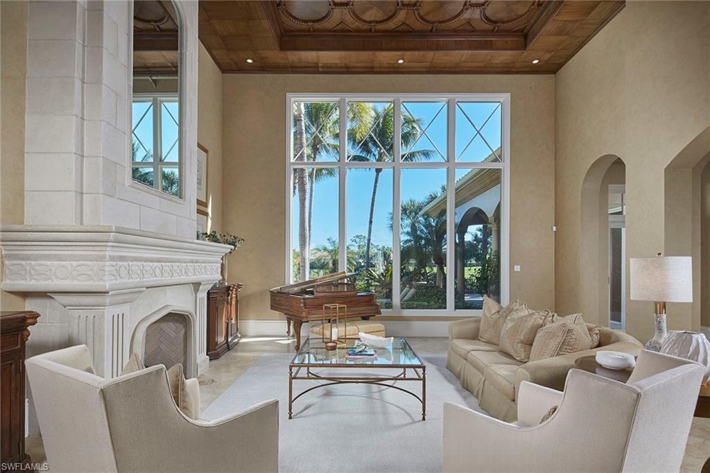2944 Bellflower Lane Naples, FL 34105 - Photo 6 of 48 a living room with furniture and a fireplace