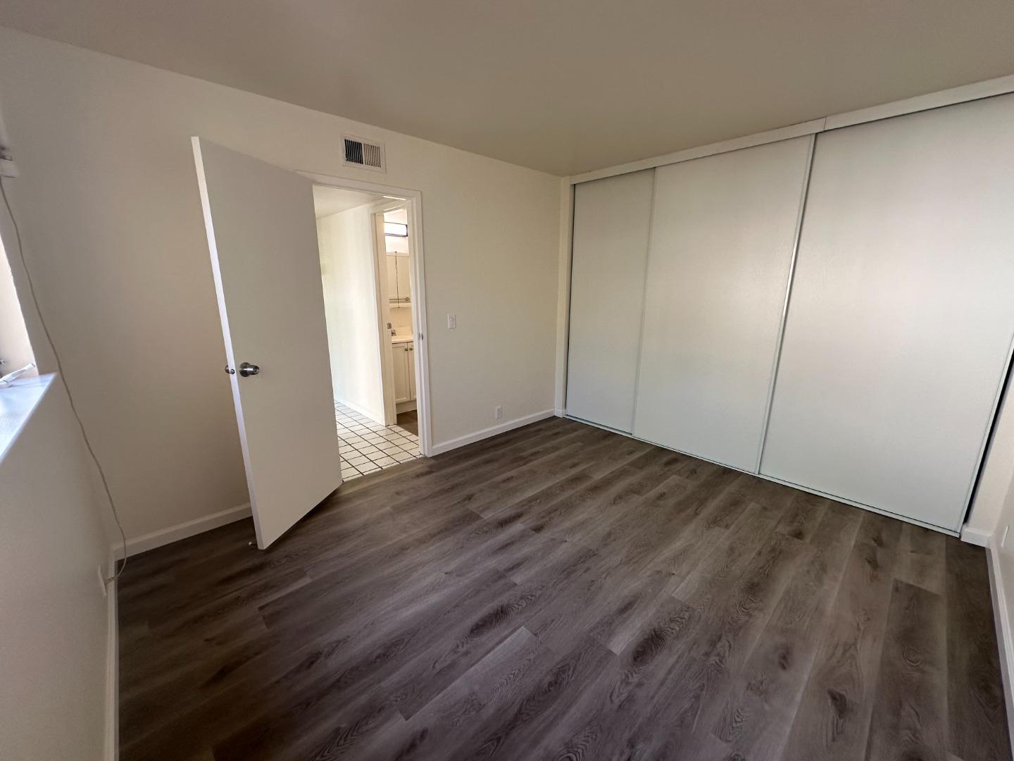 1242 Terra Nova Boulevard Pacifica, CA 94044 - Photo 13 of 26 an empty room with wooden floor and entrance