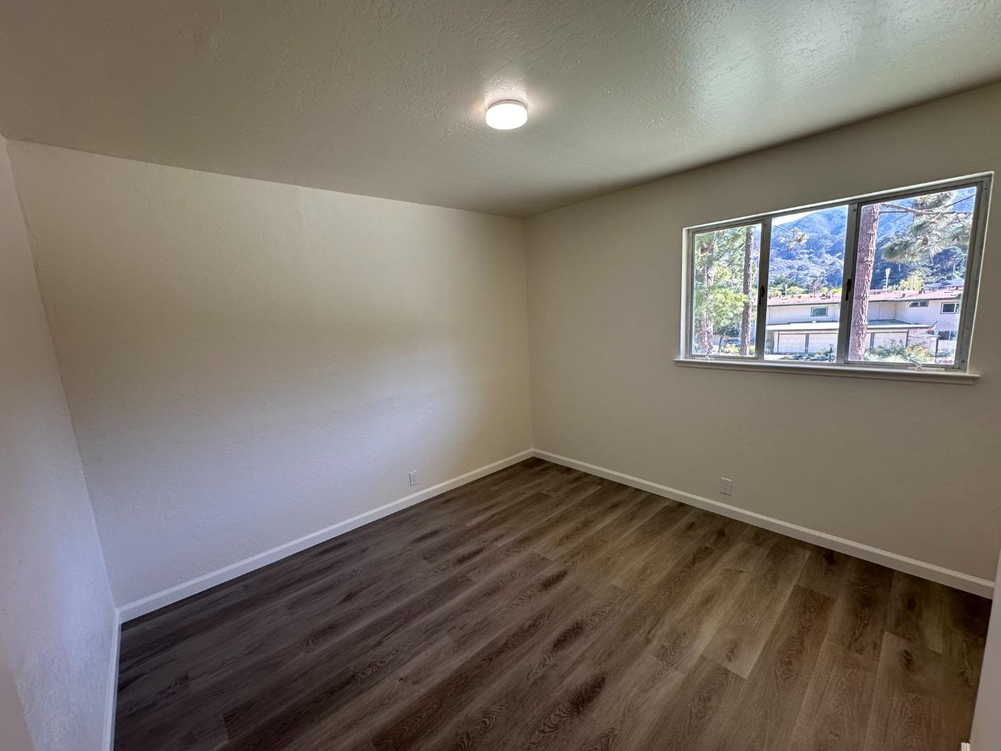 1242 Terra Nova Boulevard Pacifica, CA 94044 - Photo 14 of 26 wooden floor in an empty room with a window