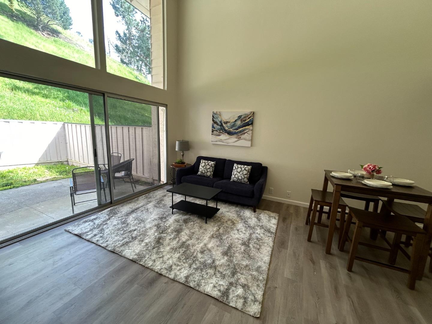 1242 Terra Nova Boulevard Pacifica, CA 94044 - Photo 2 of 26 a living room with furniture and a large window