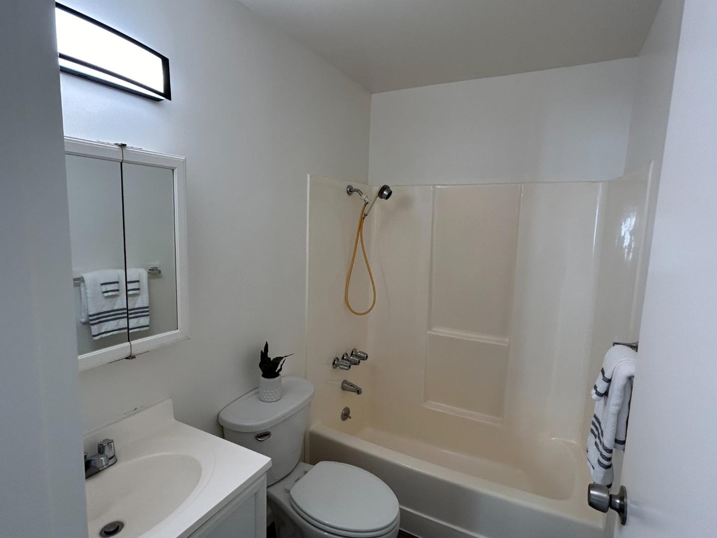1242 Terra Nova Boulevard Pacifica, CA 94044 - Photo 8 of 26 a bathroom with a toilet sink and shower