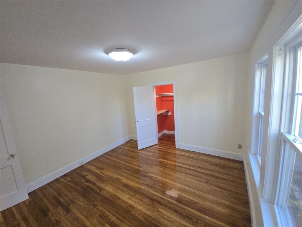 58 Creeley Road, Unit 1 Belmont, MA 02478 - Photo 13 of 15 a view of an empty room with wooden floor