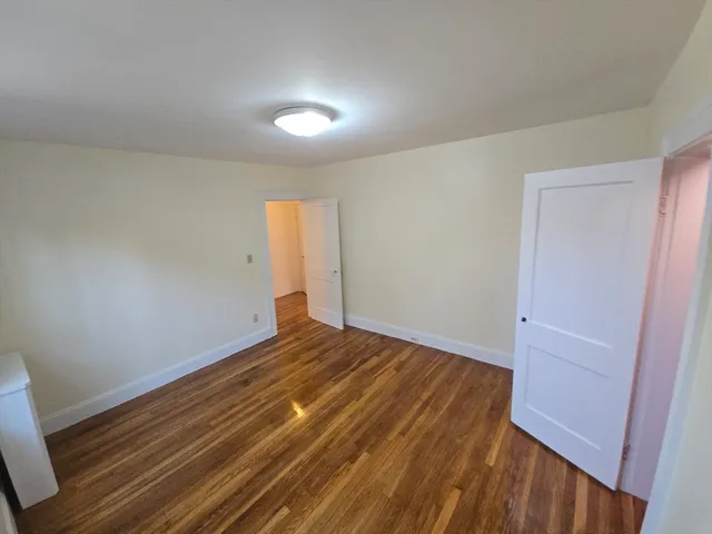 a view of room with wooden floor