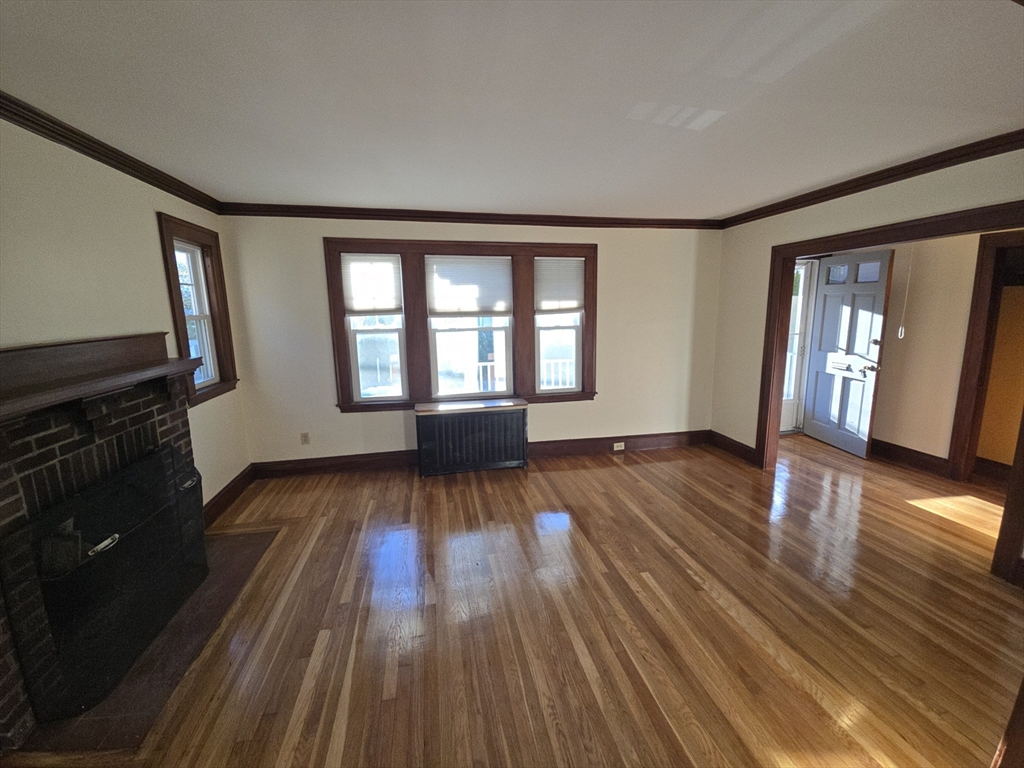 58 Creeley Road, Unit 1 Belmont, MA 02478 - Photo 3 of 15 wooden floor in an empty room with a window
