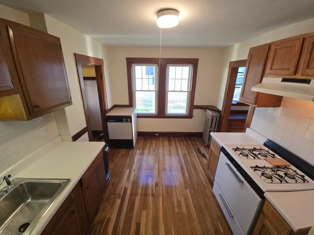 a kitchen with sink stove and refrigerator
