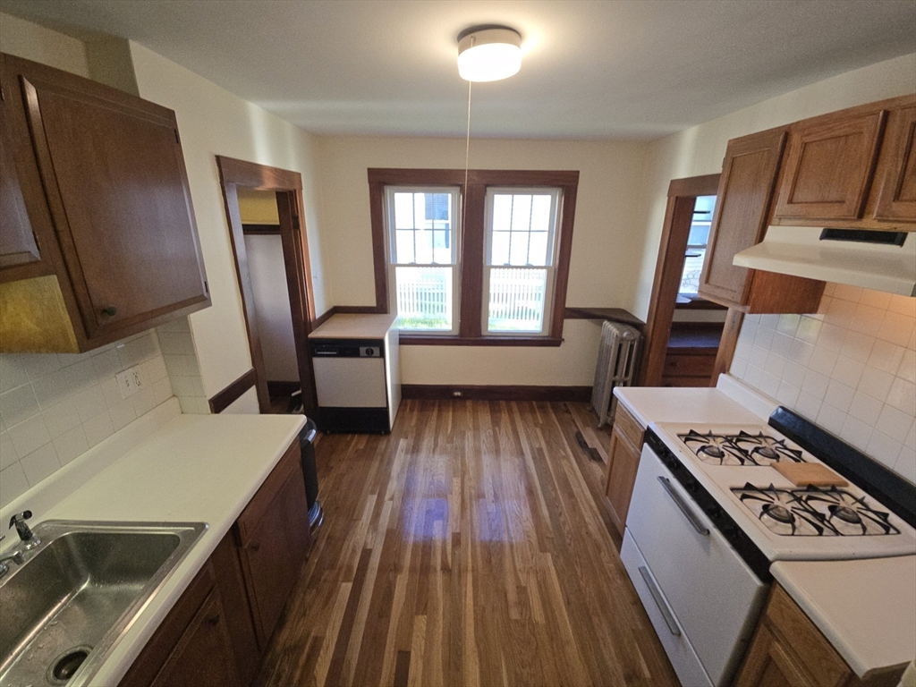 58 Creeley Road, Unit 1 Belmont, MA 02478 - Photo 6 of 15 a kitchen with sink stove and refrigerator