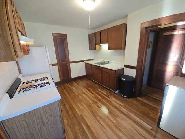 a room with wooden floor and furniture