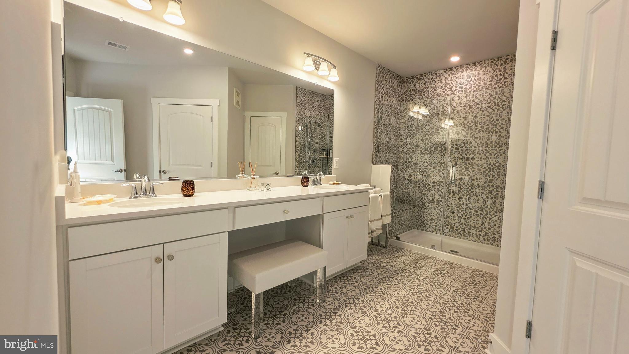 230 Switchgrass Way, Unit 21 Chester, MD 21619 - Photo 16 of 66 a bathroom with a double vanity sink mirror and shower