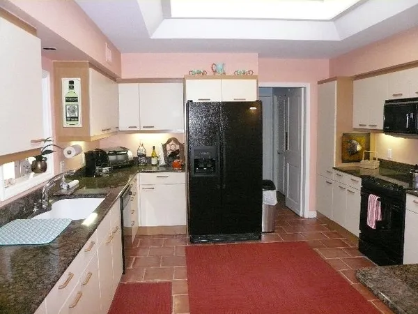 a kitchen with a refrigerator sink and stove