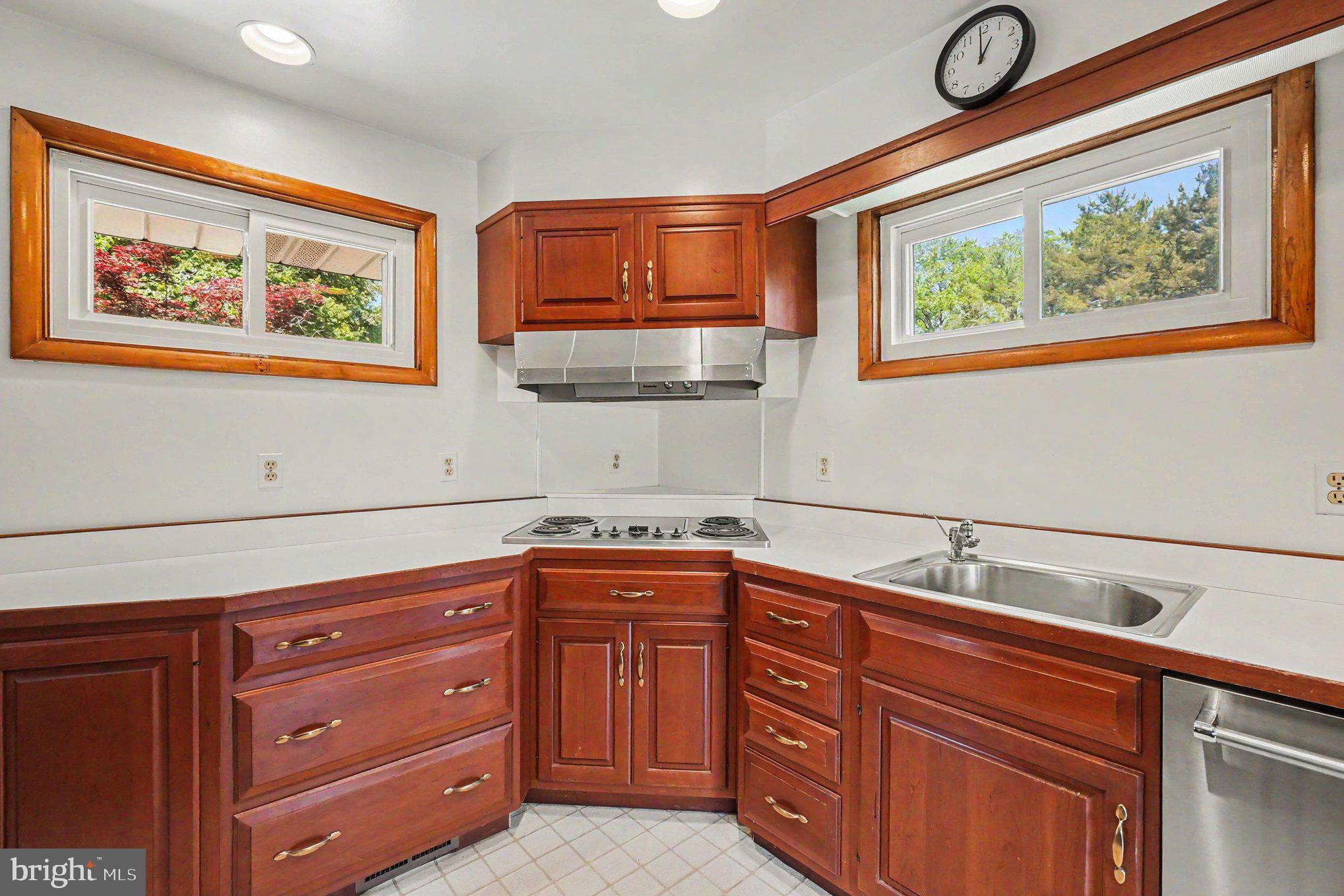 9204 Snyder Lane Perry Hall, MD 21128 - Photo 10 of 42 a kitchen with stainless steel appliances granite countertop a sink dishwasher and cabinets with wooden floor