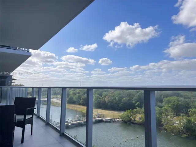 a view of a balcony with chairs and a table