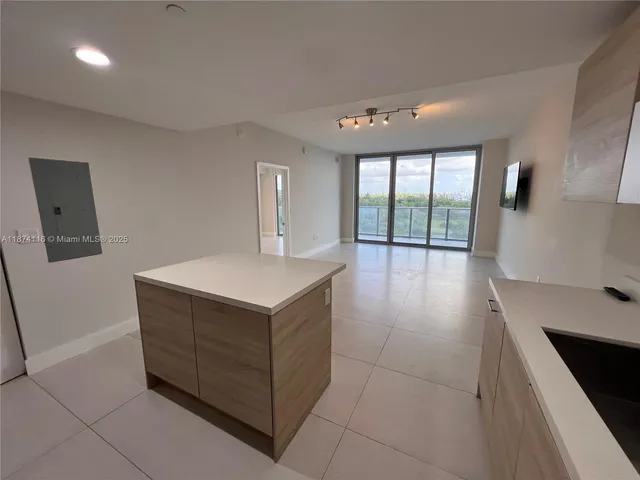 a kitchen with stainless steel appliances a refrigerator sink and cabinets