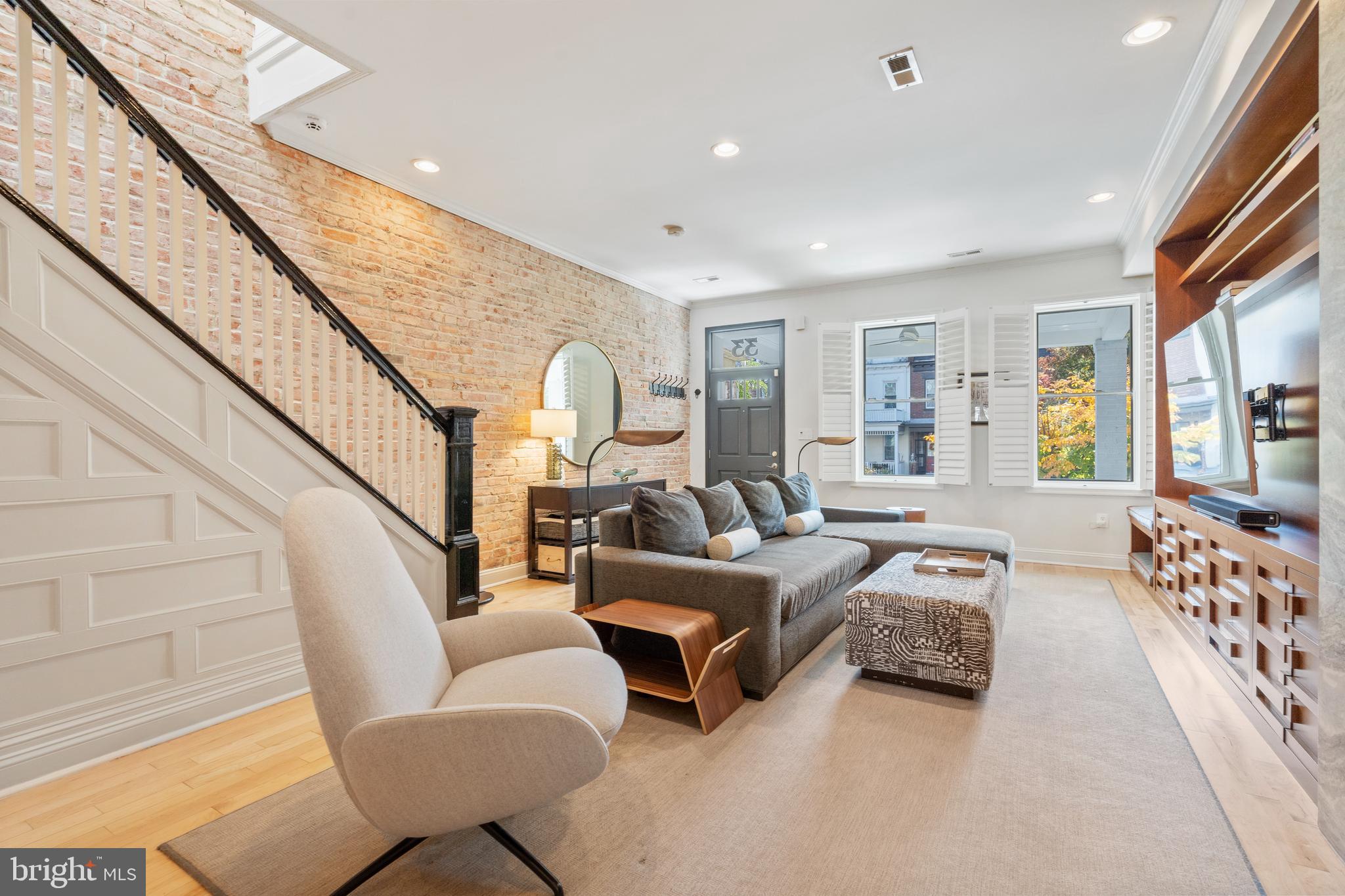 a bedroom with furniture and a large window