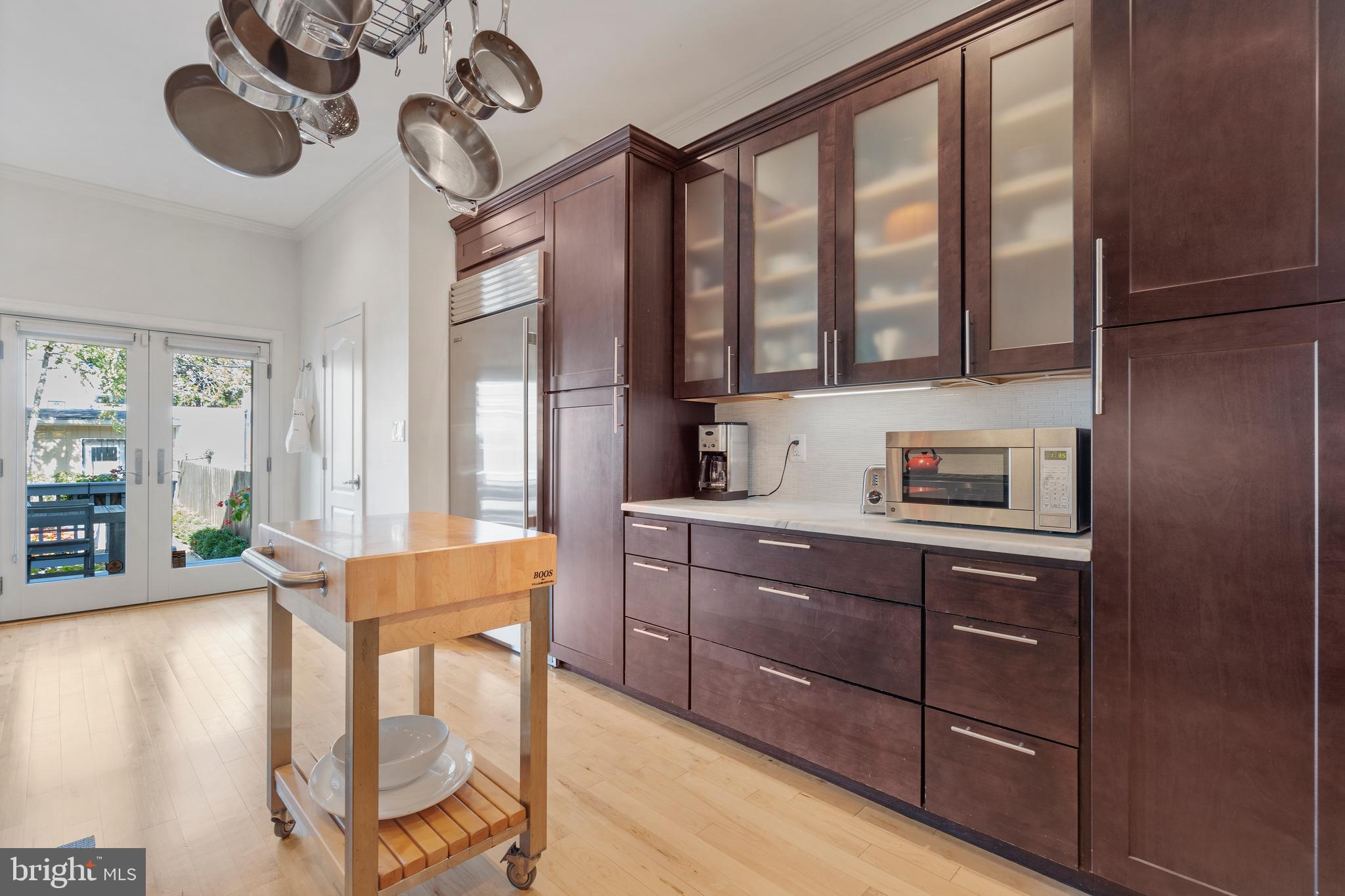 33 W Street Northwest, Unit 1 Washington, DC 20001 - Photo 14 of 36 a kitchen with stainless steel appliances granite countertop a stove a sink and a refrigerator with wooden floor