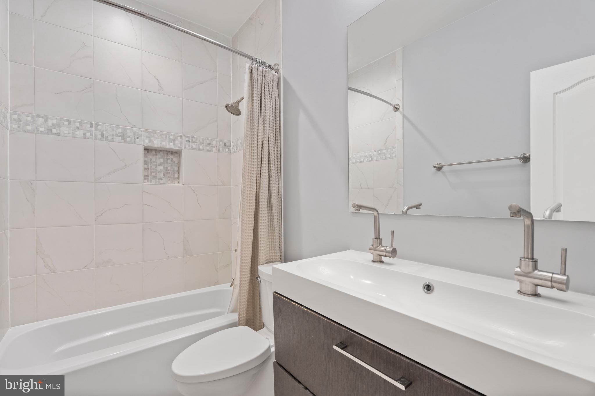 33 W Street Northwest, Unit 1 Washington, DC 20001 - Photo 20 of 36 a bathroom with a sink toilet and shower