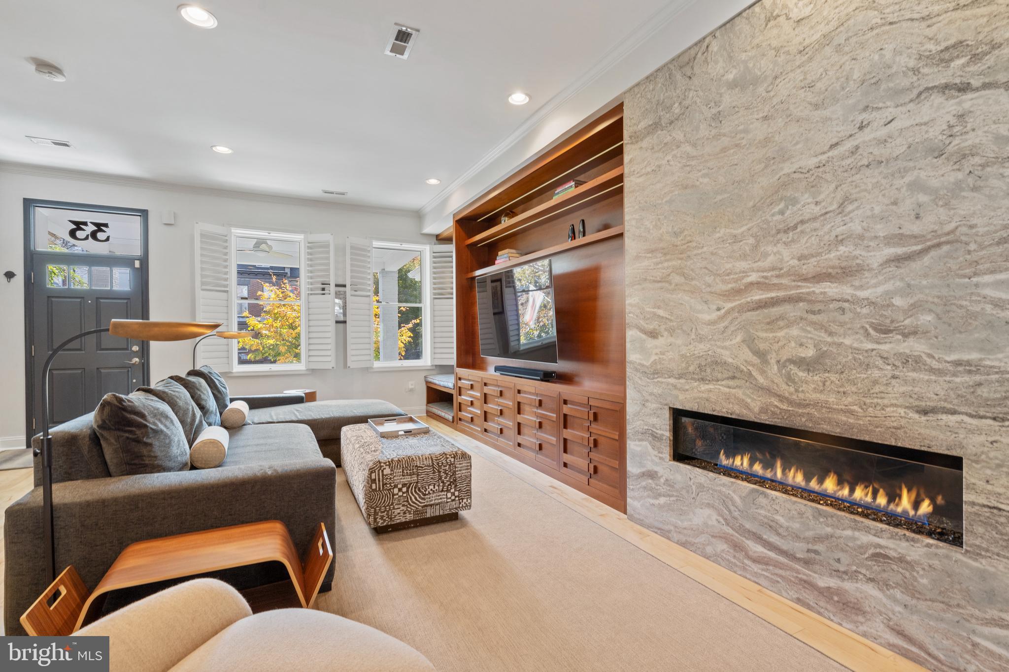 33 W Street Northwest, Unit 1 Washington, DC 20001 - Photo 2 of 36 a living room with furniture and a flat screen tv