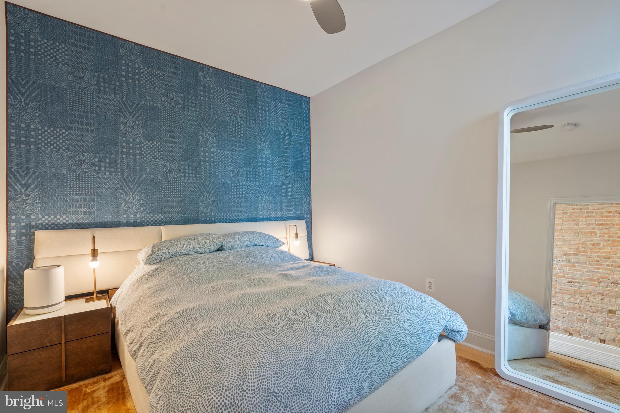 33 W Street Northwest, Unit 1 Washington, DC 20001 - Photo 25 of 36 a bed sitting in a bedroom next to a bathroom