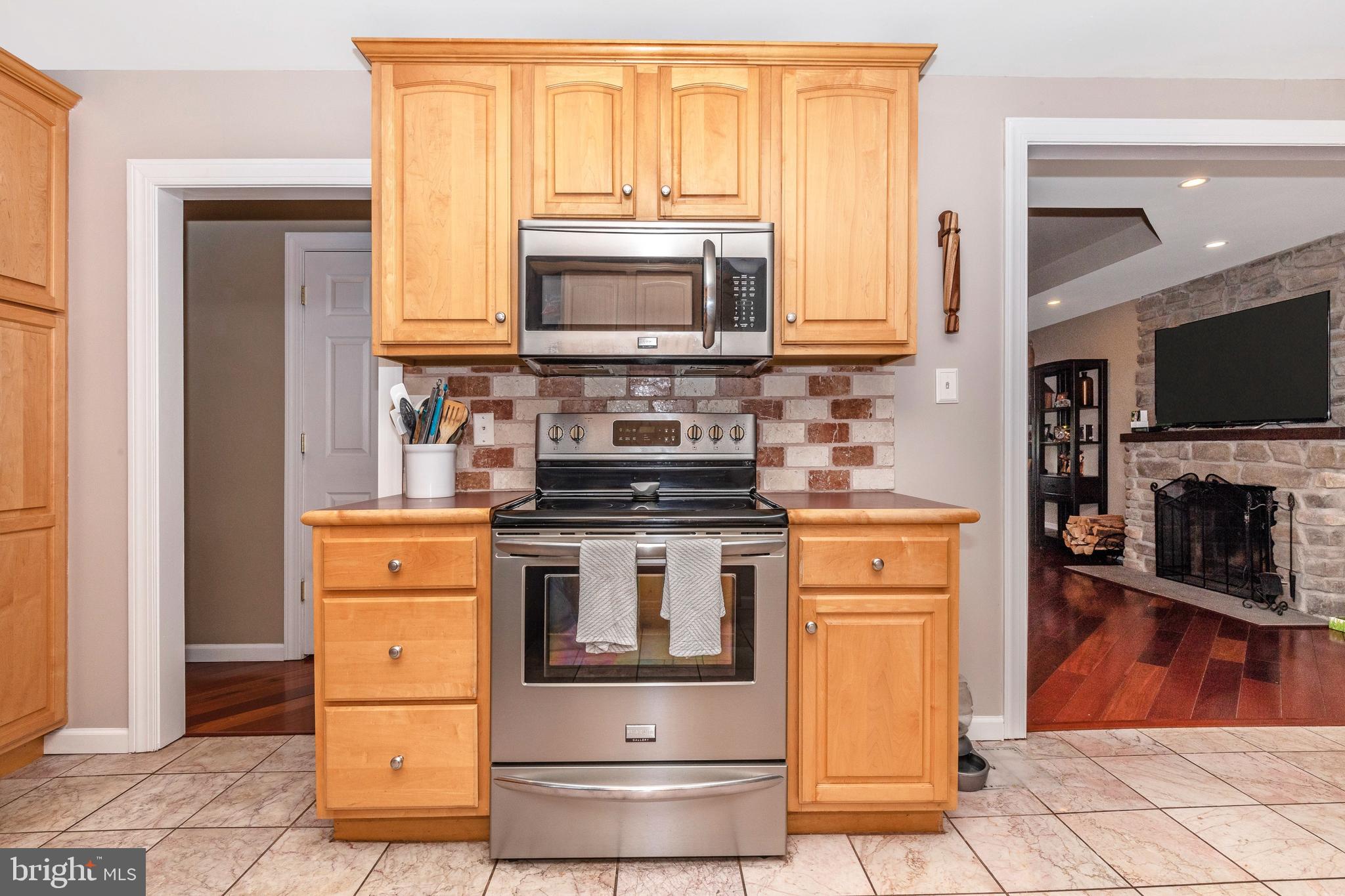 116 Pinetown Road Norristown, PA 19403 - Photo 14 of 57 Kitchen with stainless steel stove above microwave