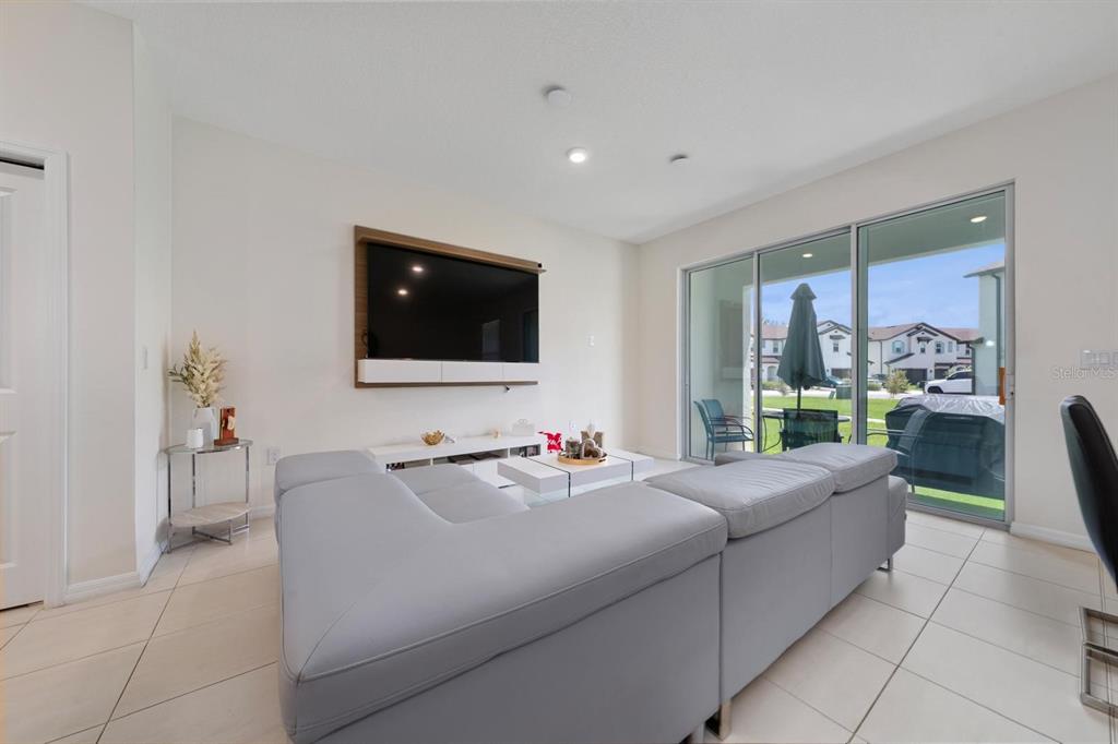 4450 Small Creek Road Kissimmee, FL 34744 - Photo 11 of 25 a living room with furniture and a flat screen tv