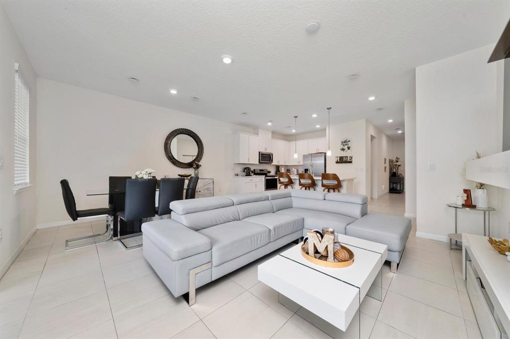 4450 Small Creek Road Kissimmee, FL 34744 - Photo 12 of 25 a living room with furniture and kitchen view
