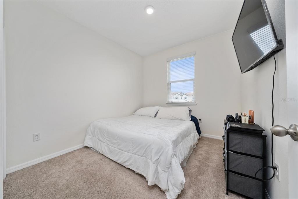 4450 Small Creek Road Kissimmee, FL 34744 - Photo 17 of 25 a bedroom with a bed and a window