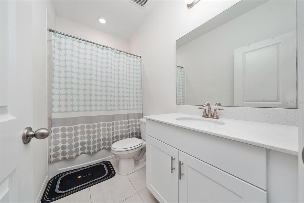 4450 Small Creek Road Kissimmee, FL 34744 - Photo 19 of 25 a bathroom with a sink toilet and shower