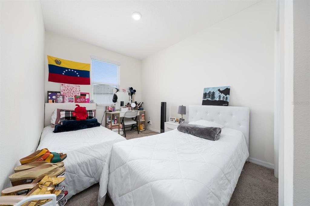 4450 Small Creek Road Kissimmee, FL 34744 - Photo 20 of 25 a bedroom with furniture and a bed