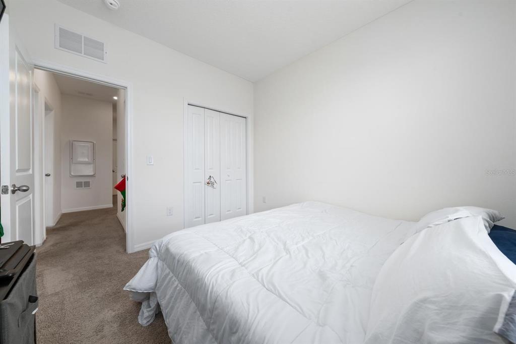 4450 Small Creek Road Kissimmee, FL 34744 - Photo 21 of 25 a bedroom with a bed and closet