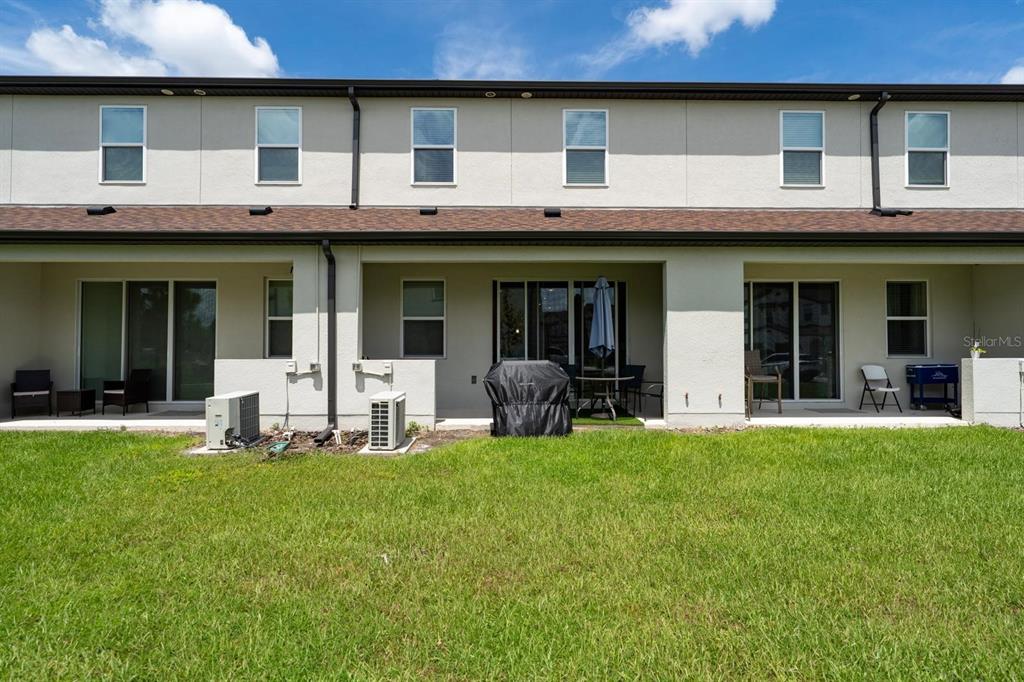 4450 Small Creek Road Kissimmee, FL 34744 - Photo 22 of 25 a house view with a sitting space and garden