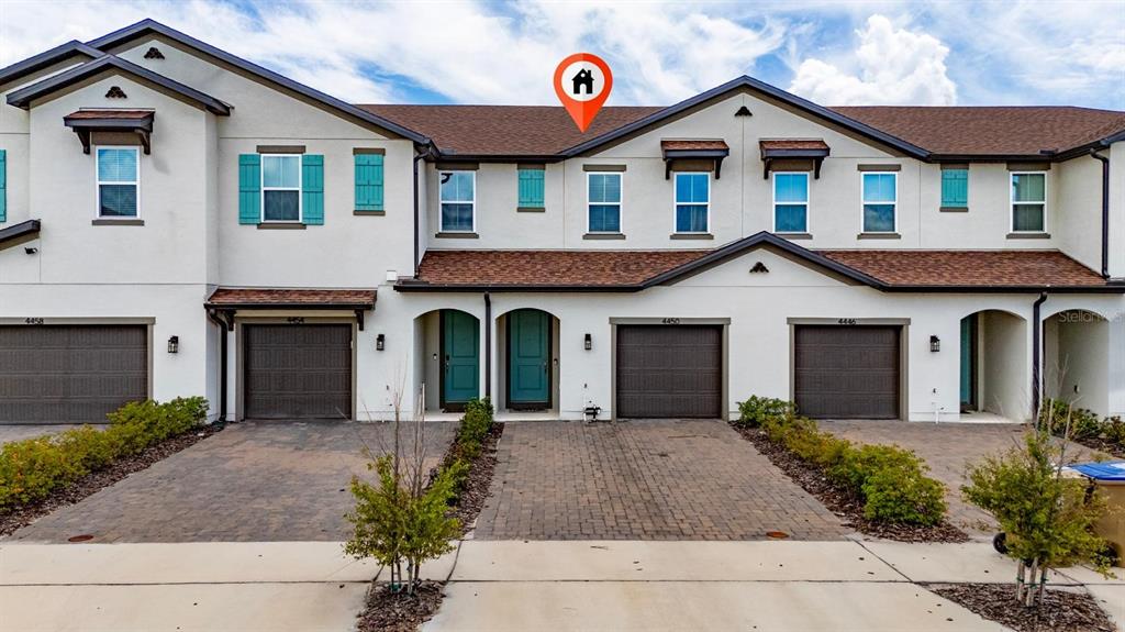 4450 Small Creek Road Kissimmee, FL 34744 - Photo 4 of 25 a front view of a house with yard