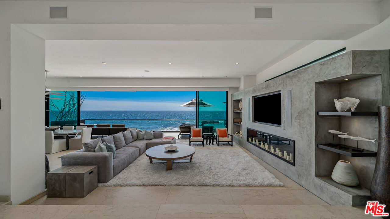 25250 Malibu Road Malibu, CA 90265 - Photo 14 of 69 a living room with furniture and a flat screen tv