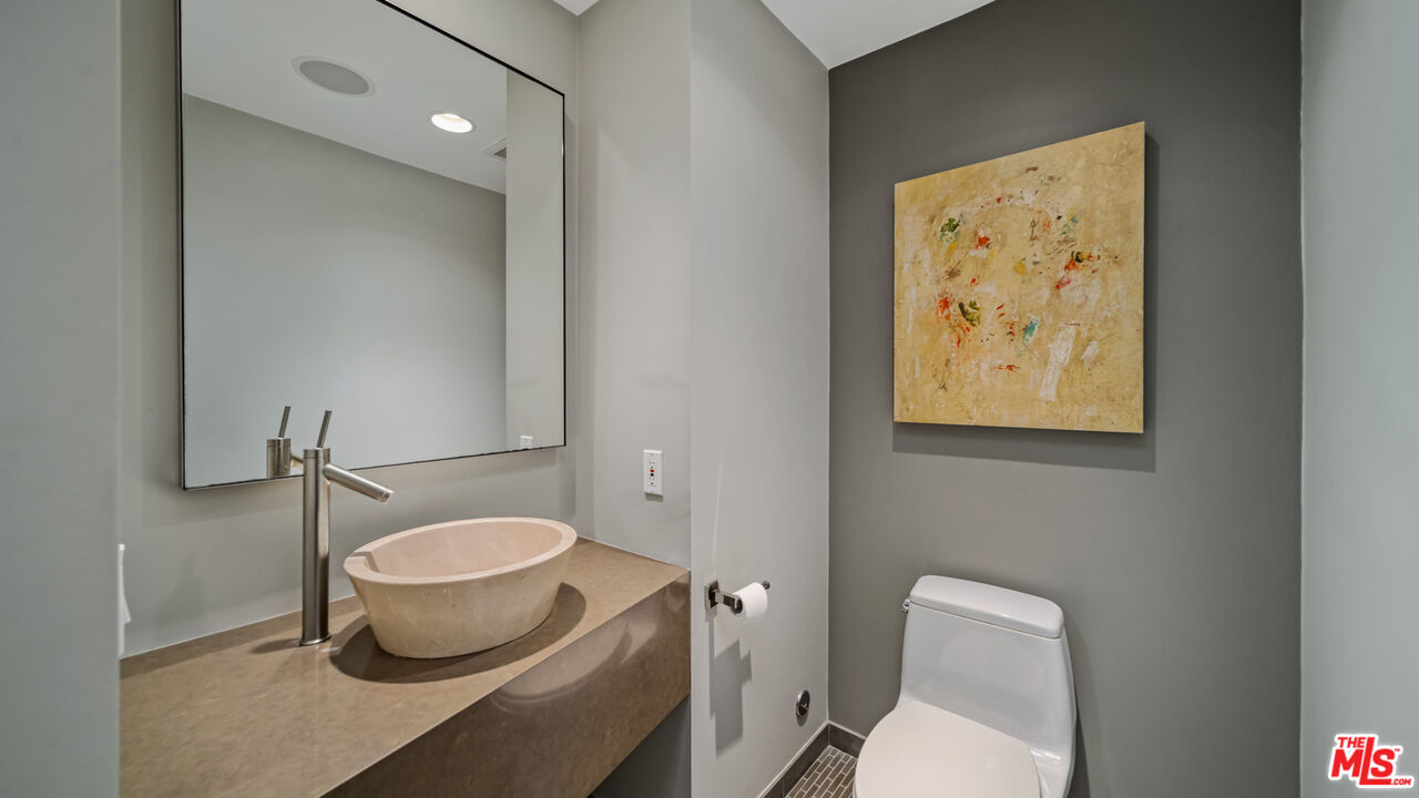 25250 Malibu Road Malibu, CA 90265 - Photo 24 of 69 a white toilet sitting next to a bathroom sink